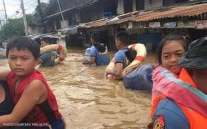 Carrying children through flood waters