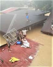 Waiting on rooftops to be rescued from flooding