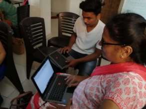 Deepa taking the exam alongside a young classmate