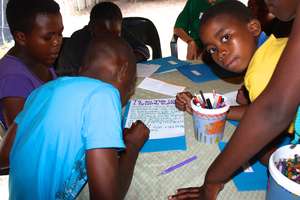 The children writing their thank you letter to you