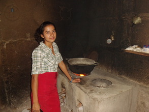 Dailia J. with her improved cookstove