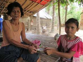 A villager donates money to support the Youth Club