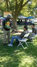 Kakari passing out flyers at a fair in Sacramento