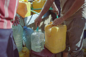Families fill up water containers