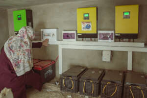 MECA Engineer Amal inspects solar panels&batteries