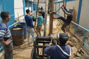 Digging water storage well at one school