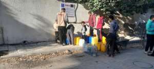 Families fill up water containers in Gaza City