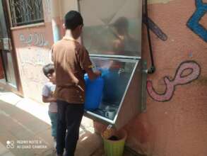 Filling up a water jug to take clean water home