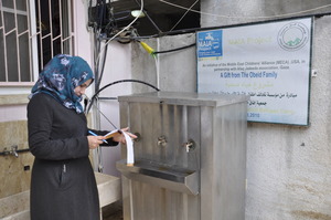Safaa tests water at school in Nuseirat, Gaza