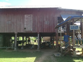 Ms. Rom in front of her homestay house