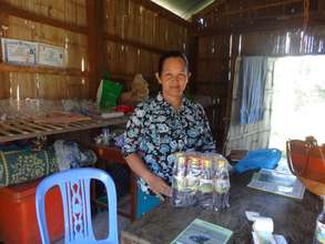 Ms. Vannara showing her fish sauce products