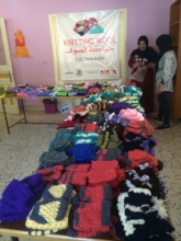 Scarves, hats, and mittens made by refugee women