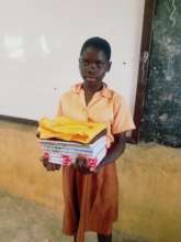 With her new uniform and books from TANF Ghana