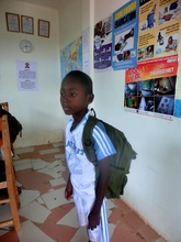 Benard with his school bag, full of books.