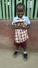 Daniel smiling after receiving his school uniform