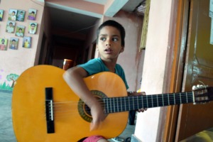 Little Krishna trying his guitar skills