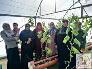 Proud women in one of their rooftop greenhouses