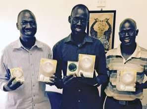 Receiving solar lights in South Sudan
