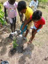 Children from the Tourama Location planting their