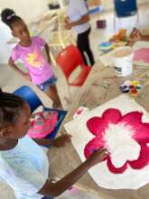 Children painting flowers for the Uptown Market
