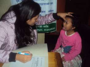 Dr.Seesam on regular health checkup of children.