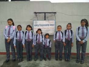 Children ready to school on new dresses and books.