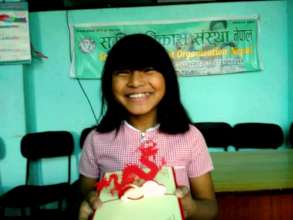 Srijana with her award receiving full-mark on MATH
