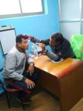 Dr. Triloki on health check up at health camp.