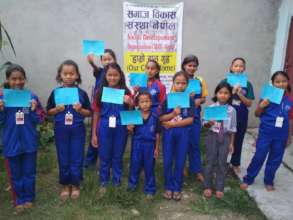 Children happily displaying their excellent result