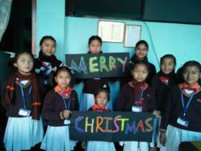 Children wishing Merry-Christmas from tiny hearts
