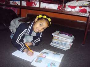 SARASWATI, Class-4, busy on home work.