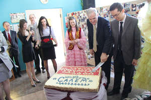 Cutting the cake at the handover party in April