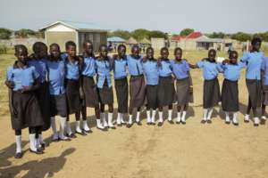 Schoolgirls pose for a picture at school in CES