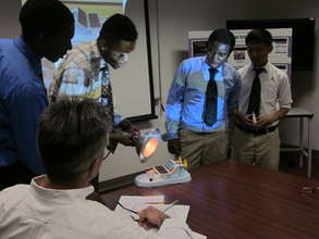 students presenting a prototype solar panel