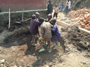 Local kids helping out by packing down dirt