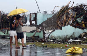 women share an umbrella - REUTERS/Erik De Castro