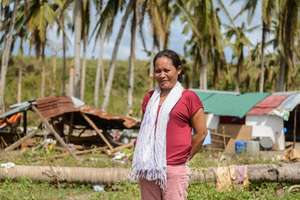 Sara Godon stands in what's left of Langub village