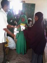 Student receiving Solar Lanterns and uniform