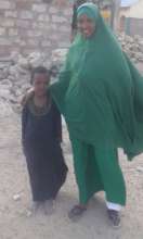 Hamida at home with her sibling