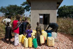 The community gets water from the water kiosk.