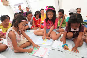 Coloring in a child-friendly space in Tacloban.