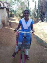 Child happily going to school with her bicycle