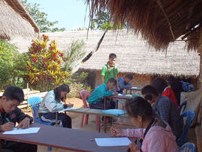 Students taking Burmese language test outside