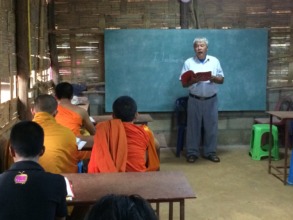 The camp headman teaching evening English class