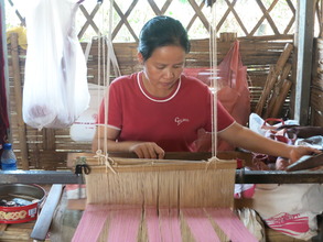 a woman from the camp weaves w/a loom from TBF