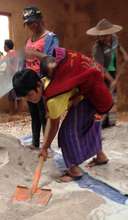 Kachin girl working with baby on her back
