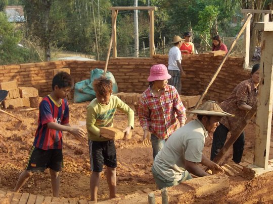 Community members working to build school