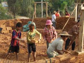 Community members working to build school
