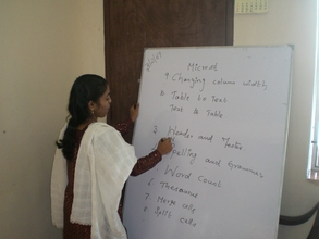 Photo - teacher goes over some computer basics
