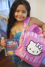 A new backpack brings big smiles to a little girl